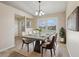 Elegant dining room with a modern table, comfortable seating, and a large window offering backyard views at 2801 W Covington Dr, Deltona, FL 32738