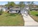 Aerial front view of a single story home with a long driveway and green lawn at 2801 W Covington Dr, Deltona, FL 32738