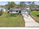Charming single-story home with a well-manicured lawn and a long driveway leading to a two-car garage at 2801 W Covington Dr, Deltona, FL 32738