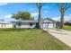Inviting single-story home with a spacious front yard and attached two-car garage, perfect for a Gathering at 2801 W Covington Dr, Deltona, FL 32738