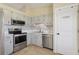 Well-equipped kitchen with stainless steel appliances, stylish backsplash, and a pantry for ample storage at 2801 W Covington Dr, Deltona, FL 32738