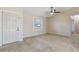 Inviting living room featuring neutral paint, tile floors, a ceiling fan, and a bright window at 2801 W Covington Dr, Deltona, FL 32738