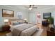 Serene main bedroom with hardwood floors, soft colors, and an ensuite bathroom for added privacy and convenience at 2801 W Covington Dr, Deltona, FL 32738