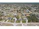 An aerial view of the house in a residential neighborhood with a forest in the distance at 2801 W Covington Dr, Deltona, FL 32738