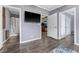 Modern living room with light gray walls, access to the bathroom, and a mounted tv at 36010 Kalamazoo Dr, Eustis, FL 32736