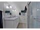 Bathroom featuring double sinks, modern lighting, and a glass-enclosed shower at 3725 Swindell Rd, Lakeland, FL 33810