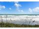 A scenic view of waves crashing along the shore, showcasing the beauty of the coastal landscape at 4325 S Atlantic Ave # C10, New Smyrna Beach, FL 32169