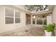 Back patio area featuring covered seating, brick flooring, and access to a fenced yard at 4527 Sunset Ln, Oviedo, FL 32765