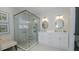 Bathroom featuring double sinks, and a glass-enclosed shower with a bench at 4527 Sunset Ln, Oviedo, FL 32765