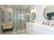 Bathroom featuring double sinks, and a glass-enclosed shower with a bench and sitting chair at 4527 Sunset Ln, Oviedo, FL 32765