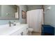 Well-lit bathroom with a vanity, toilet, a mirror, and a shower with curtain at 4527 Sunset Ln, Oviedo, FL 32765