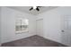 Simple bedroom with neutral walls, carpet flooring, and a window bringing in natural light at 4527 Sunset Ln, Oviedo, FL 32765