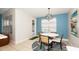 Charming breakfast nook with a modern light fixture, a round table, and blue accent wall at 4527 Sunset Ln, Oviedo, FL 32765
