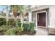 Home featuring an inviting entrance, well-manicured shrubs, a secure ADT sign, and a covered front porch at 4527 Sunset Ln, Oviedo, FL 32765
