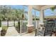 Charming front porch featuring a classic rocking chair, brick-base columns, and a view of the landscaped yard at 4527 Sunset Ln, Oviedo, FL 32765