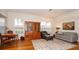 Bright living room showcasing hardwood floors, large windows, a stylish area rug, and comfortable seating arrangements at 4527 Sunset Ln, Oviedo, FL 32765