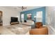 Inviting living room with an accent wall, lots of natural light, tile flooring, and stylish contemporary decor at 4527 Sunset Ln, Oviedo, FL 32765