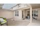 Private outdoor patio area, featuring brick pavers, an attached roof, comfortable seating, and views of the home at 4527 Sunset Ln, Oviedo, FL 32765