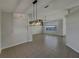 Open dining area featuring a modern chandelier and seamless flow to the living spaces at 4845 Sw 134Th Loop, Ocala, FL 34473