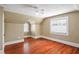 Bedroom featuring angled ceilings, hardwood floors, a ceiling fan, and two windows at 501 Sheridan Blvd, Orlando, FL 32804