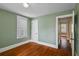 Bedroom with two windows, hardwood floors, and neutral colored walls at 501 Sheridan Blvd, Orlando, FL 32804