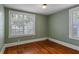 Small bedroom featuring two windows and hardwood floors at 501 Sheridan Blvd, Orlando, FL 32804