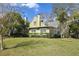 Charming two-story home with a well-maintained lawn, mature trees, and classic architecture at 501 Sheridan Blvd, Orlando, FL 32804