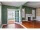 Sun-filled living room features decorative fireplace with mosaic tile, hardwood floors, and an open doorway at 501 Sheridan Blvd, Orlando, FL 32804