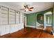The spacious living room features hardwood floors, a custom built-in bookcase, and access to the staircase at 501 Sheridan Blvd, Orlando, FL 32804