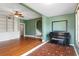 Open-concept living room with hardwood floors, mosaic tile accents, staircase, and custom built-in bookcase at 501 Sheridan Blvd, Orlando, FL 32804