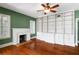 Spacious living room features hardwood floors, a fireplace, and a custom built-in bookcase with white cabinetry at 501 Sheridan Blvd, Orlando, FL 32804