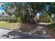 Lush yard featuring mature trees, a two-car garage, and access to rear of the home at 501 Sheridan Blvd, Orlando, FL 32804