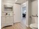 Well-lit bathroom with white vanity, mirror, toilet, and doorway to the conference room at 5150 Old Howell Branch Rd, Winter Park, FL 32792