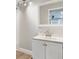 Bathroom featuring a vanity with white cabinets, neutral countertop and a framed mirror at 5150 Old Howell Branch Rd, Winter Park, FL 32792