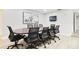 Spacious conference room with a large table, comfortable chairs, and a wall-mounted TV at 5150 Old Howell Branch Rd, Winter Park, FL 32792