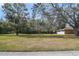 A picturesque view of a spacious front yard with mature trees and lush greenery at 5150 Old Howell Branch Rd, Winter Park, FL 32792