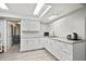 Convenient kitchenette features white cabinetry, granite countertops, and modern fixtures at 5150 Old Howell Branch Rd, Winter Park, FL 32792