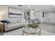 Cozy living room with modern decor, features a bookshelf, modern art, and comfortable seating at 5150 Old Howell Branch Rd, Winter Park, FL 32792