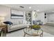 Comfortable living room with stylish decor, features a bookshelf, modern art, and comfortable seating at 5150 Old Howell Branch Rd, Winter Park, FL 32792