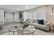 Comfortable living room with stylish decor, featuring a large window and decorative coffee tables at 5150 Old Howell Branch Rd, Winter Park, FL 32792