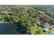 Stunning lakefront property features mature trees, water access, a pool and an outdoor patio for outdoor enjoyment at 5203 Pineview Way, Apopka, FL 32703