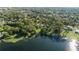 Stunning lakefront property showcasing a spacious lot, mature trees, and a charming home along the water's edge at 5203 Pineview Way, Apopka, FL 32703