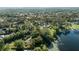 Stunning lakefront property showcasing a spacious lot, mature trees, and a charming home along the water's edge at 5203 Pineview Way, Apopka, FL 32703