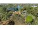Lakefront home surrounded by lush greenery with a gazebo and large trees at 5203 Pineview Way, Apopka, FL 32703
