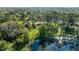 Home overlooking a tranquil lake, surrounded by lush greenery and mature trees at 5203 Pineview Way, Apopka, FL 32703