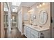 Bathroom with double vanity, skylight, and adjacent toilet and shower at 5203 Pineview Way, Apopka, FL 32703