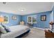 Cozy bedroom with two windows, blue walls, and neutral carpeting at 5203 Pineview Way, Apopka, FL 32703