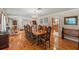 Elegant dining room with a large wooden table, chandelier lighting, and hardwood floors at 5203 Pineview Way, Apopka, FL 32703