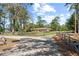 Beautiful brick home features a well-manicured lawn, mature trees, and charming wood fence at 5203 Pineview Way, Apopka, FL 32703