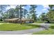 Charming single-story home with a well-manicured front yard, long driveway, and car port at 5203 Pineview Way, Apopka, FL 32703